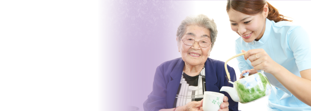 the elderly woman with the caregiver showing a happy face